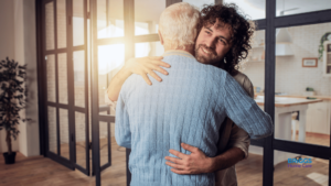 son providing emotional support for aging parent